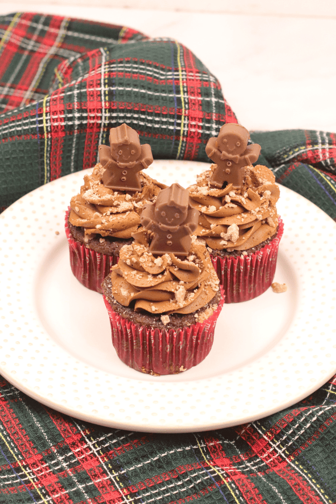 3 gingerbread men cupcakes on white plate