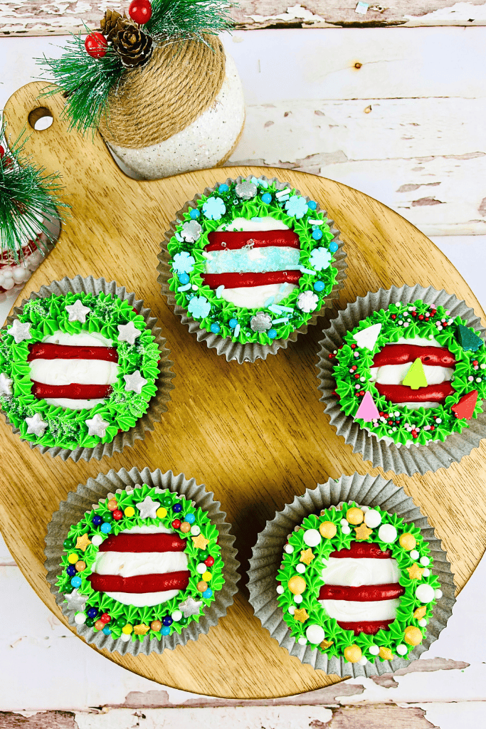 5 wreath cupcakes on wooden board