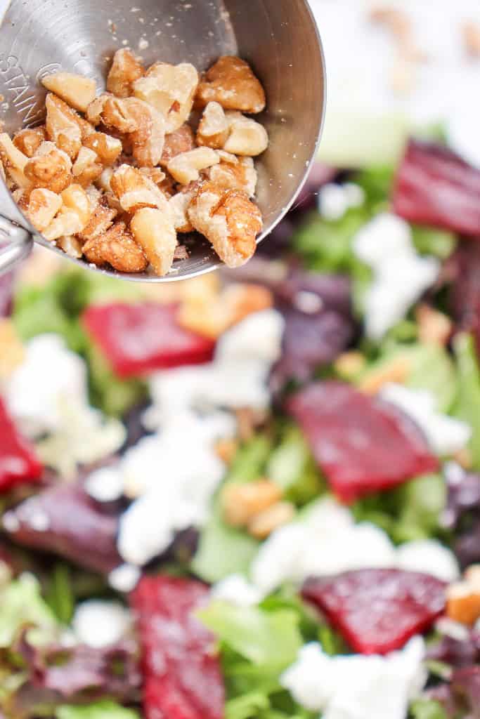 adding chopped walnuts to Grilled Beetroot Goat Cheese Salad