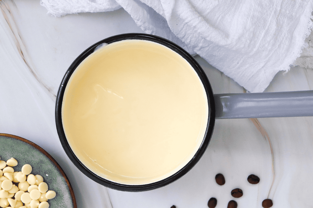 mixing up white chocolate chips and cream