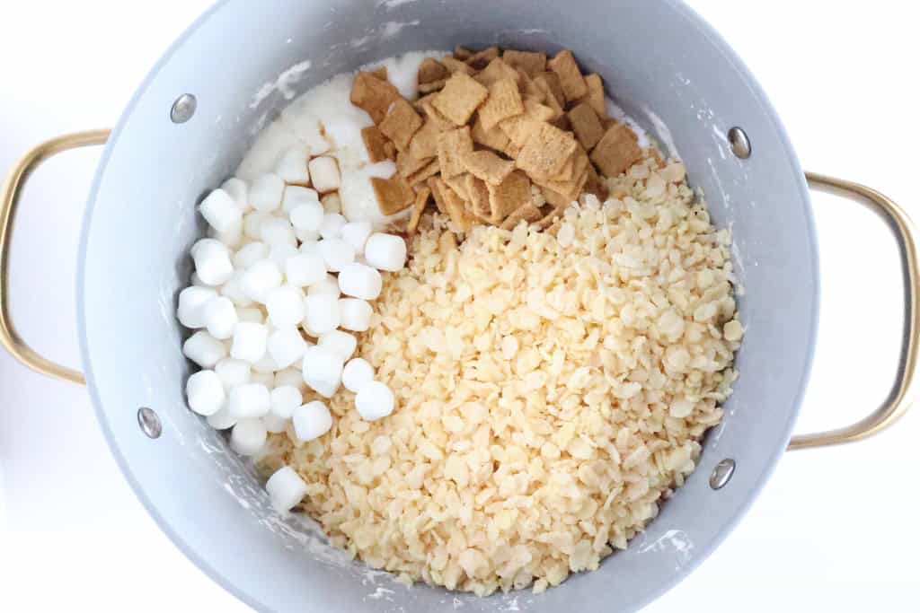 Mixing ingredients of S'mores Rice Krispies in pan