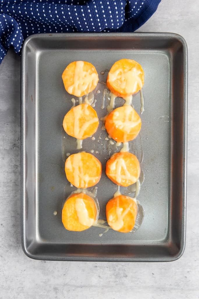 sweet potato slices arranged in baking tray