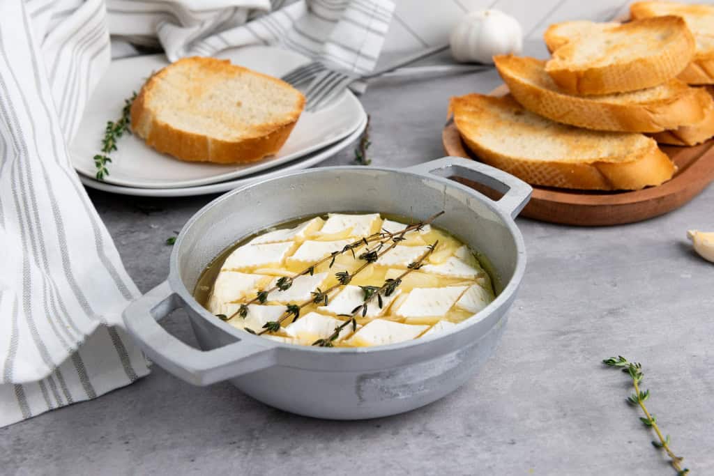 Baked Garlic Brie and plates of toasted bread