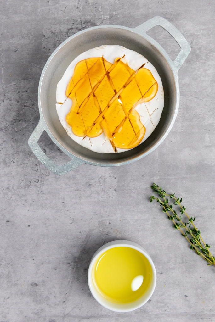 honey drizzled over the brie wheel