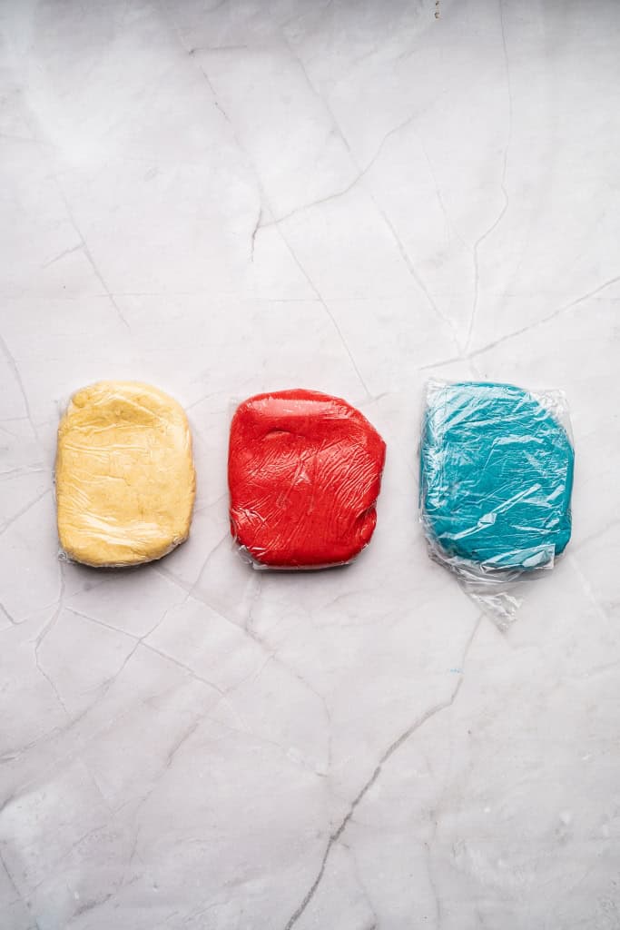 plan, red, blue dough shaped into rectangles and wrapped in plastic wrap