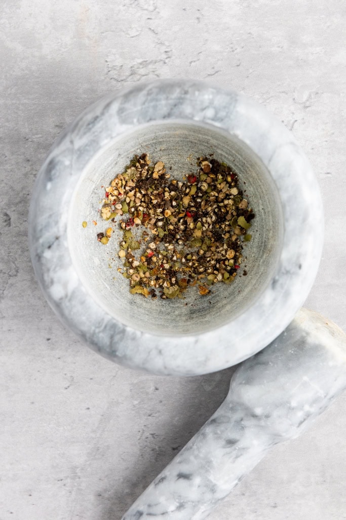 crush peppercorns with mortar and pestle